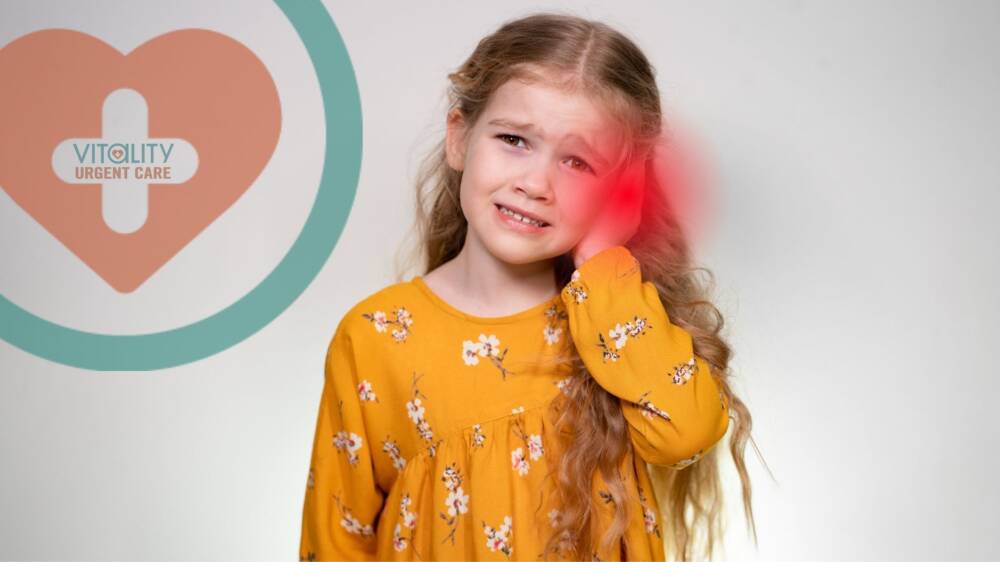 Child holding ear in pain from ear infection